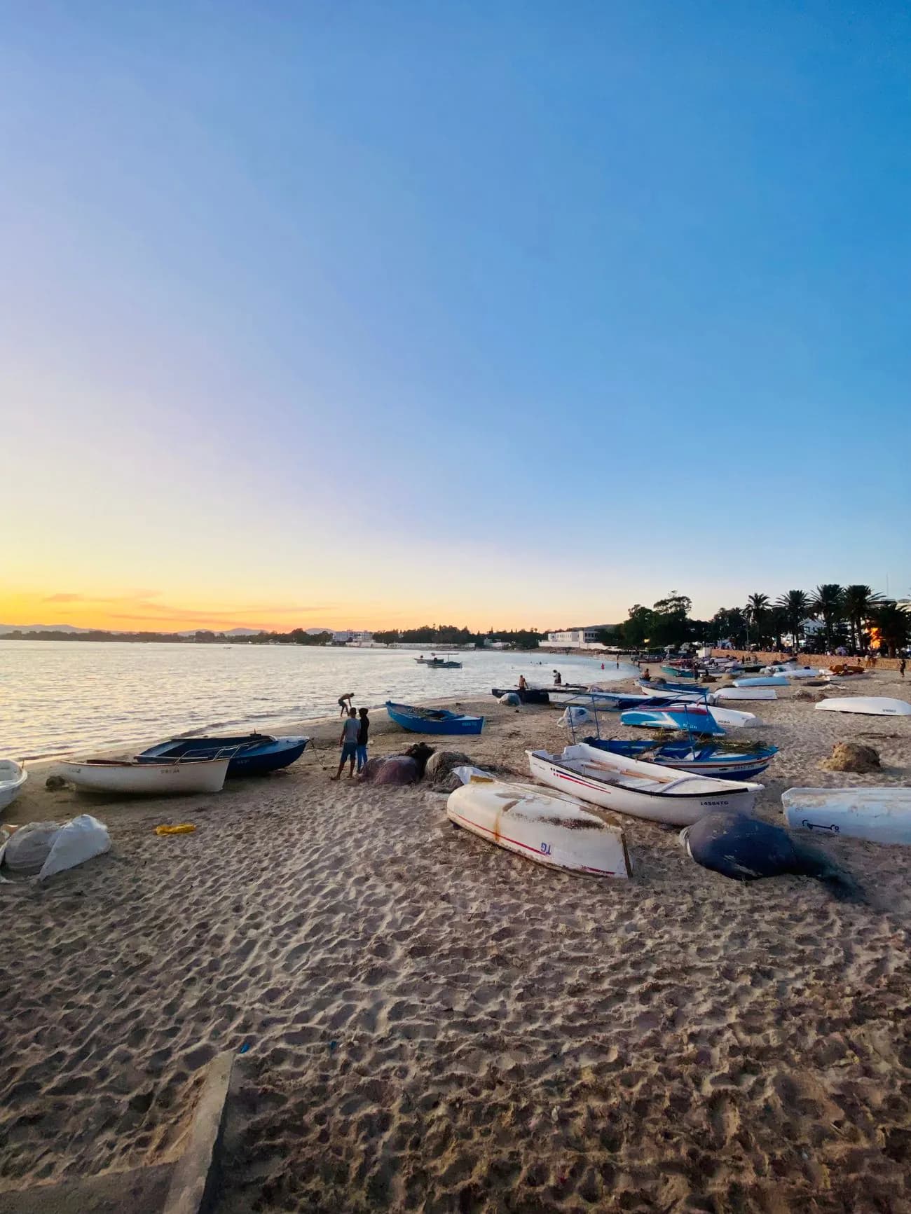 Fishing boats pulled up on the beach in Hammamet at sunset