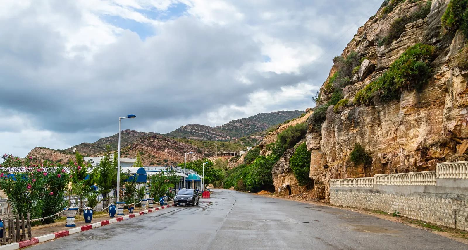 The coast road at Korbous beneath green cliffs