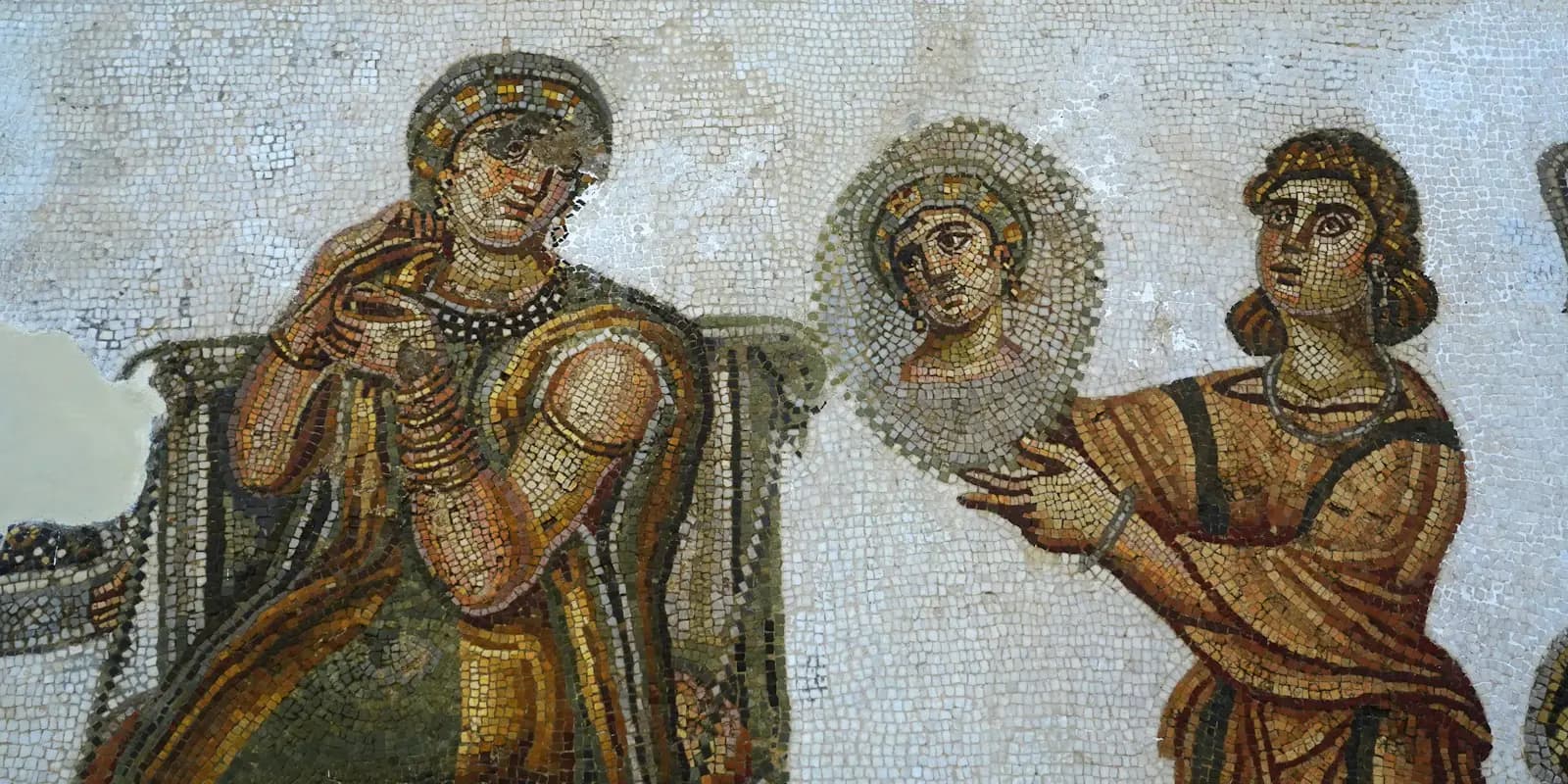 A Roman floor mosaic with figures in ochre and blue tones
